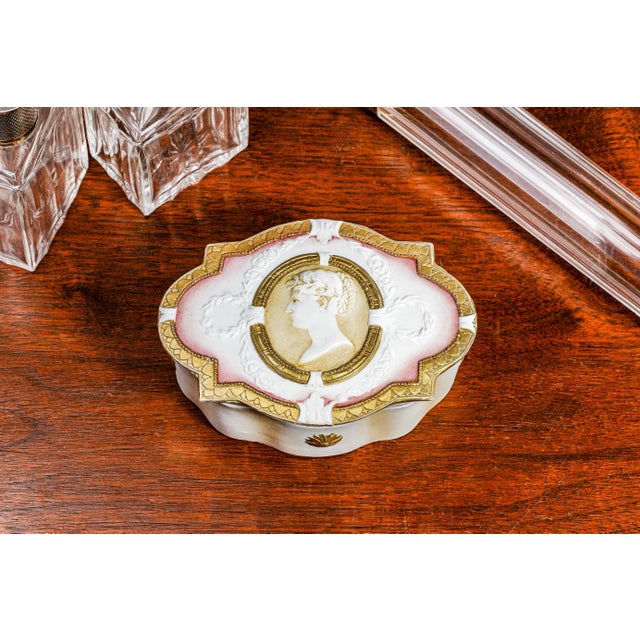 This charming circa-1895 German porcelain jewelry box embodies the refined elegance of Neoclassical design, executed in...