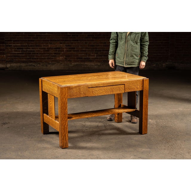 Solid oak coffee table executed in the Mission / Arts & Crafts tradition, defined by rectilinear proportions, exposed...