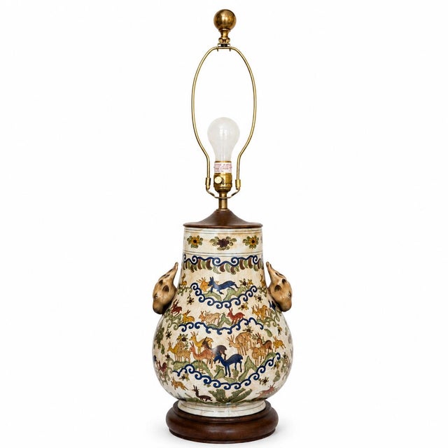 Elegant chinoiserie-style porcelain table lamp featuring colorful hand-painted animal and floral motifs with bold cobalt...