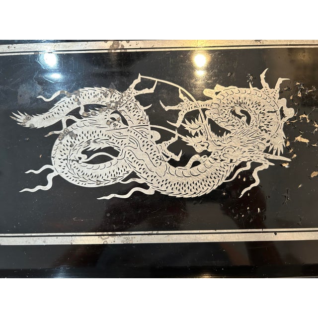 A striking pair of vintage Japanese serving trays, each with hand-etched silver designs on a glossy black ground. One...