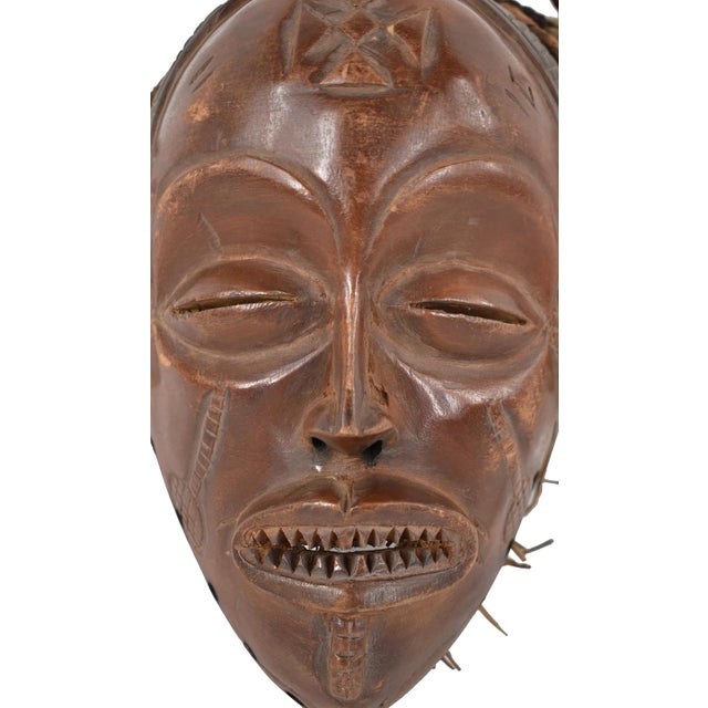 This mask comes from the Chokwe. The headdress attached to the mask is well preserved. The face shows typical Chokwe...