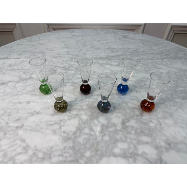 Add a vibrant pop of retro-modern charm to your bar cart with this striking set of six handblown cordial shot glasses....