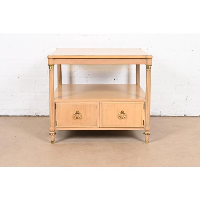 A gorgeous French Regency Louis XVI style two-tier tea table or occasional side table By Baker Furniture USA, Circa 1960s...