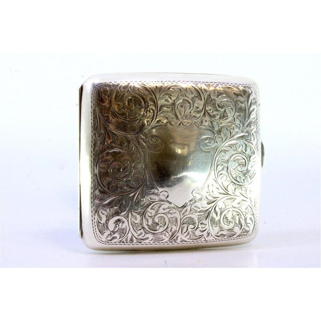 Curved Silver Cigarette Case with Plant Motifs, in Very Good conditions. Designed 1890 to 1919 This piece has an...