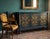 A true statement piece, this hand-painted credenza features a sophisticated geometric star-patterned inlay, set against a...