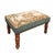 Meticulously handcrafted in the United Kingdom, this upholstered stool boasts classic studding and hand-polished solid...