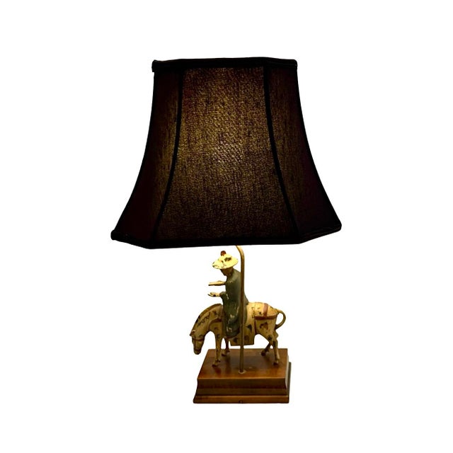 This scholar figurine on horse metal and wood lamp adds a touch of vintage charm to any room. The unique design features...