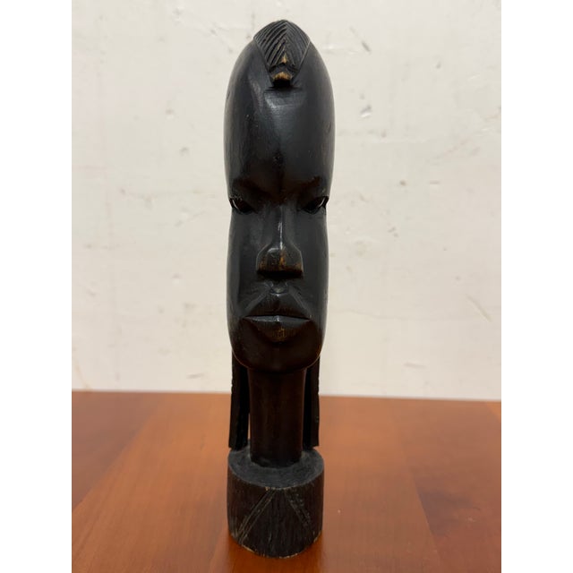 Design Plus Gallery presents a Carved African Wood Head Sculpture. Defined by an elongated form and stylized facial...