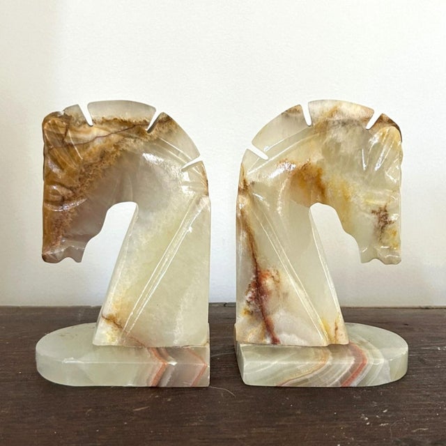 A truly stunning pair of horsehead bookends. Stylized features - note carving at the mane and mouth of both pieces - speak...