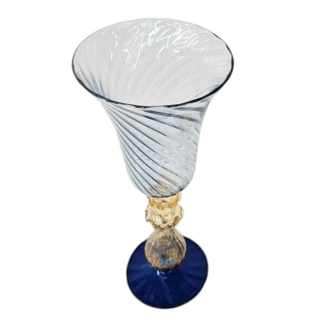 Striking vintage Venetian Murano hand-blown art glass chalice featuring a pale ice-blue spiral optic bowl, shimmering gold...
