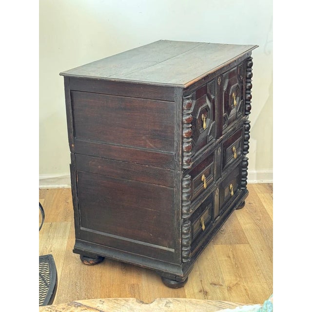 A Charles II style Joined Oak Chest of Drawers, Circa 1780-1800. In two parts. The molded rectangular boarded top above...