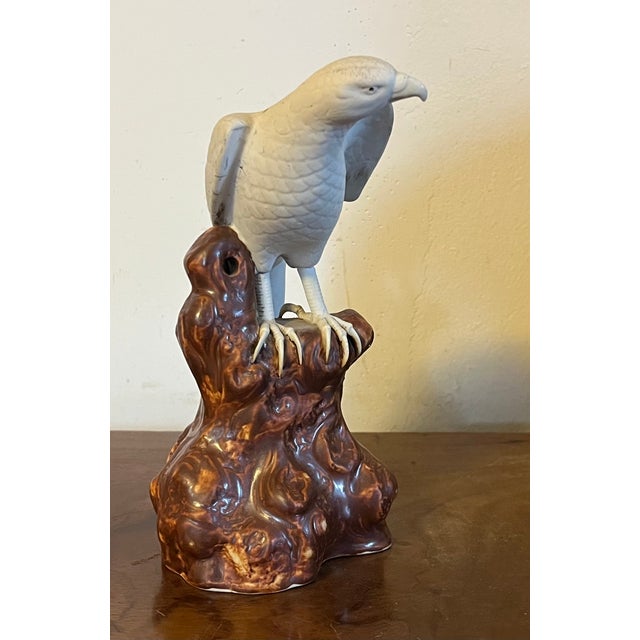 Antique 19th century Japanese Meiji porcelain figure of a white hawk standing atop rock work with its wings spread....
