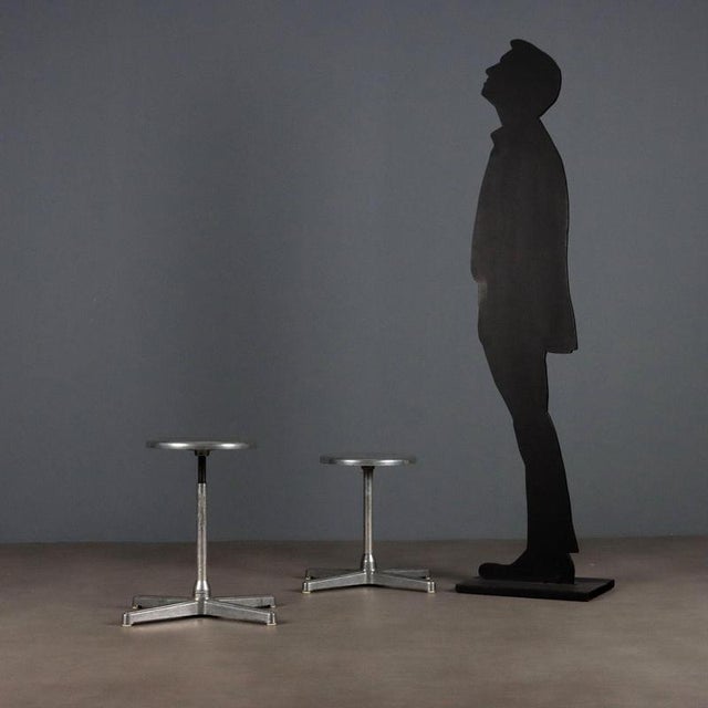 Pair of vintage metal stools with adjustable-height seat and four-star legs. This piece is attributed to the mentioned...