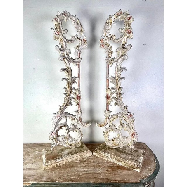 A pair of 19th-century carved Italian architectural elements mounted on wood bases. The Rococo style carvings showcase...