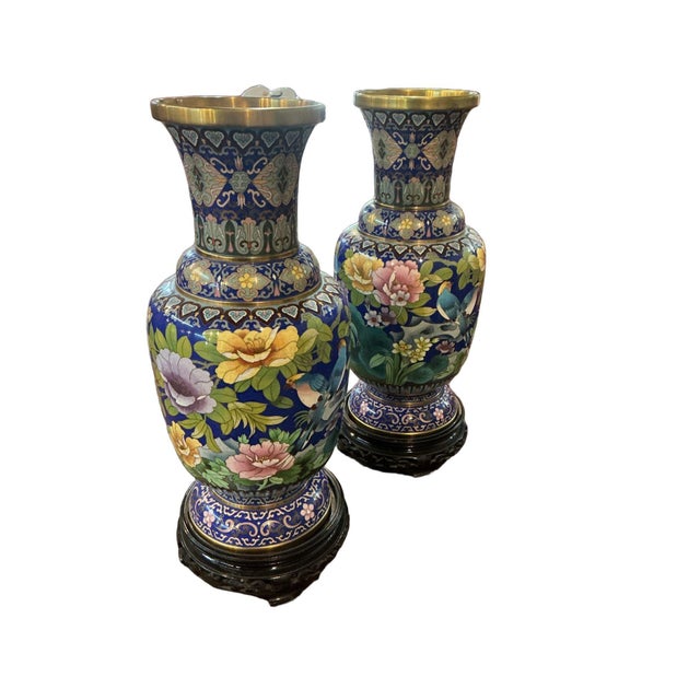 Beautiful pair of Chinese cloisonné vases, featuring intricate bird and floral enamel designs on a blue background. With...
