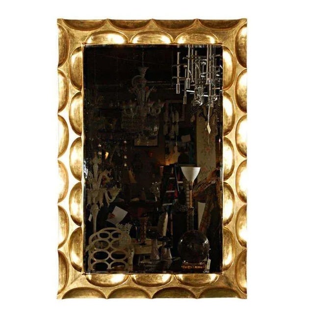A vintage gilded hand-carved 'honeycomb' mirror by Bryan Cox. It is gilded in real 22-karat gold and has a beautiful deep...
