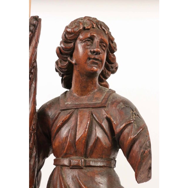 An impressive pair of Italian carved wooden angel candelabra or torchères, dating to the late 16th to early 17th century....