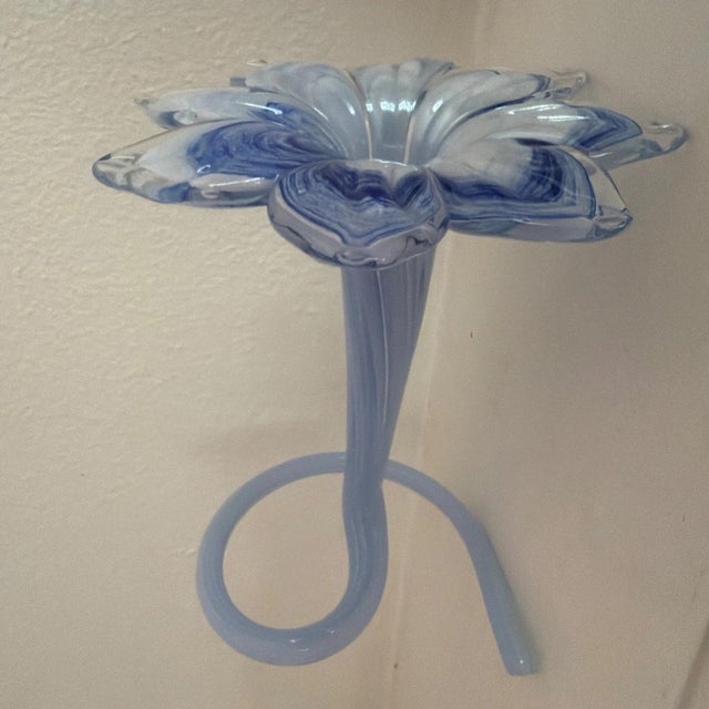 The Lavorazione Arte Glass Flower Blue Bud Vase is a beautifully crafted decorative piece made from glass. The vase...