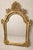 An elegant late 19th-century Rococo Revival mirror, richly finished in warm, hand-applied gilt and crowned with a dramatic...