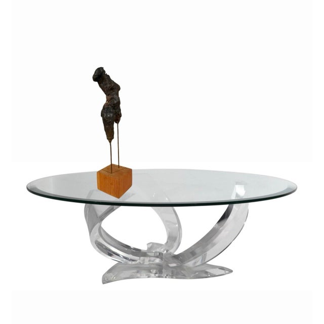 Handsome bronze abstract female sculpture mounted with brass rods to a wood block base. Unsigned, standing 14.75” high...