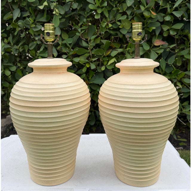 Vintage ribbed ceramic table lamps with sculptural rounded forms and a hand-painted finish in warm cream, beige, and...