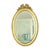 French oval gold mirror with a bow and ribbon around it; the frame is made of wood, the mirror glass is beveled, Baroque...