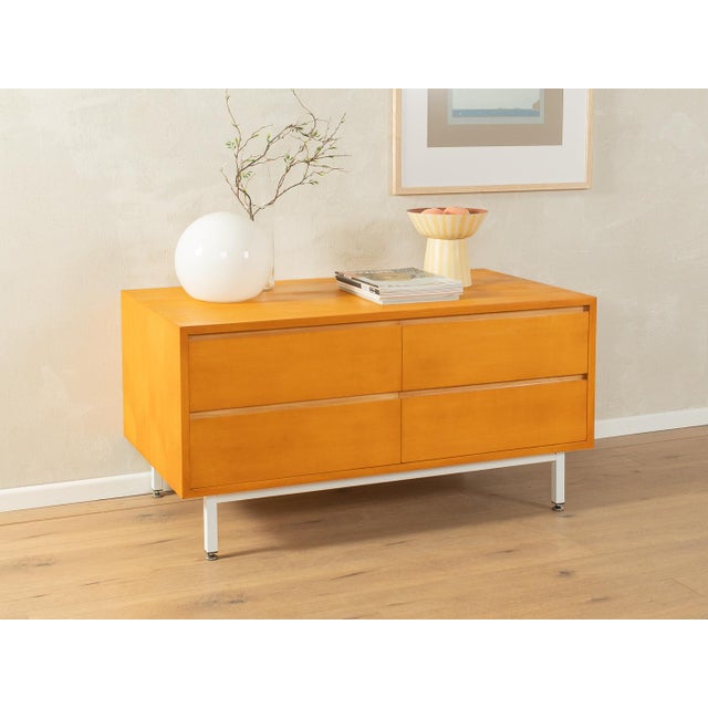 Classic sideboard from the 1960s by WK Möbel. Cherry veneer body with four drawers and new white square steel feet....