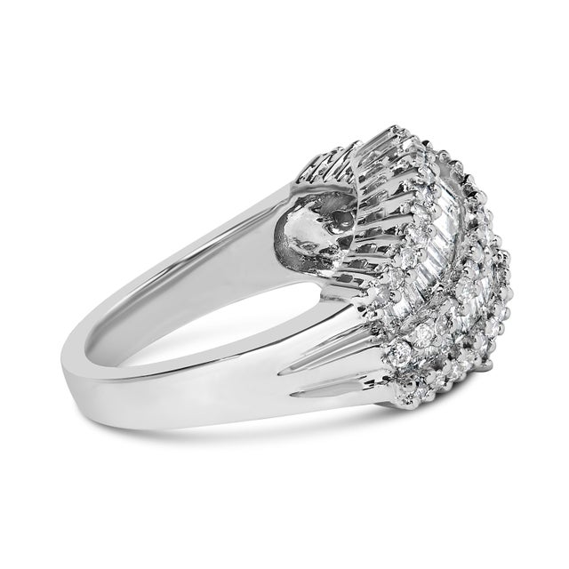 This striking diamond cocktail ring features seven rows of alternating round and baguette diamonds. This glistening ring...