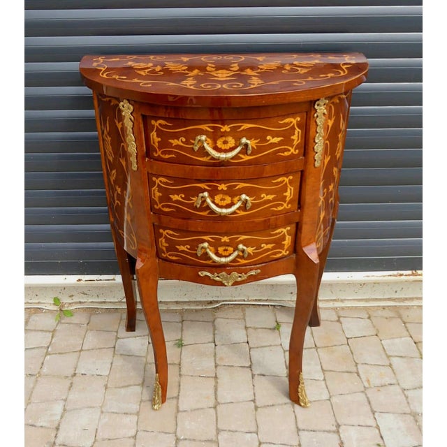 Elegant and practical, this French demi-lune side table is crafted from durable solid wood and showcases beautiful floral...