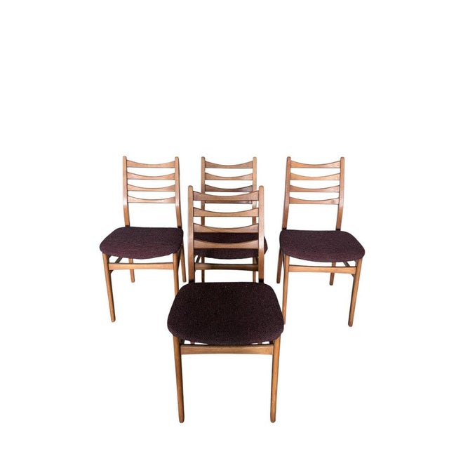 A set of four mid-century dining chairs, produced in the former gdr (east germany), featuring classic ladder back design....
