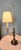 Brass and wood with an age-appropriate patina. This lamp has been well taken care. ***no branding is found on the lamp