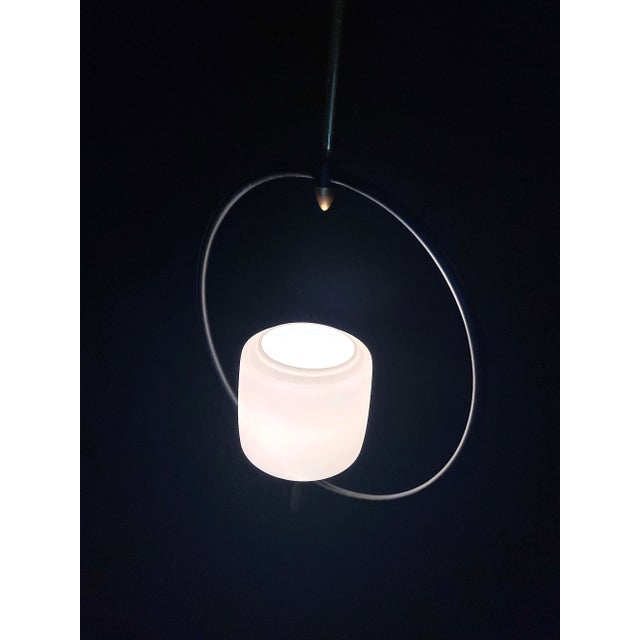 So elegant, simple and beautiful pendant, the frame is in black metal, with brass details, and a beautiful circular...