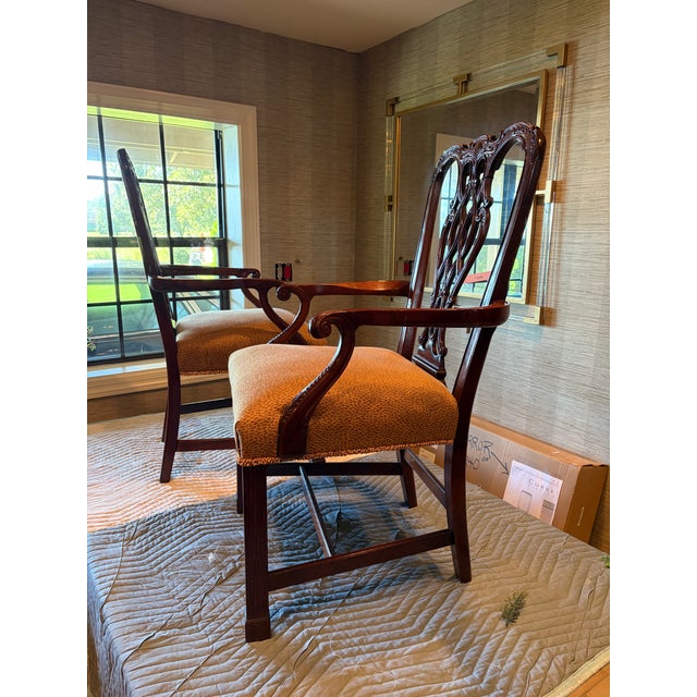 These 2 Century Furniture Dining Chairs with arms chairs are carved mahogany with custom upholstery and decorative trim on...