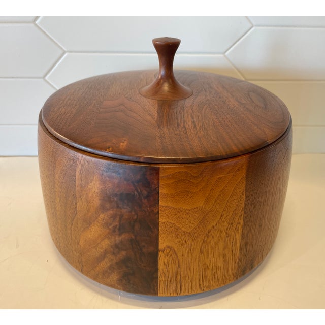A rare and stunning, modernist design in a solid teak wood ice bucket, maker unknown. Plastic insert keeps wood safe from...
