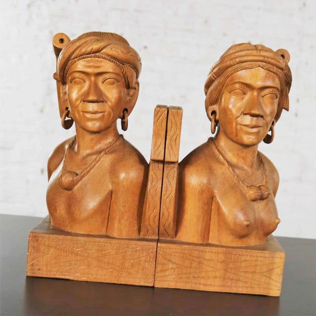 Handsome pair of hand carved wood tribal figural bookends. One male and one female. They are in fabulous vintage...