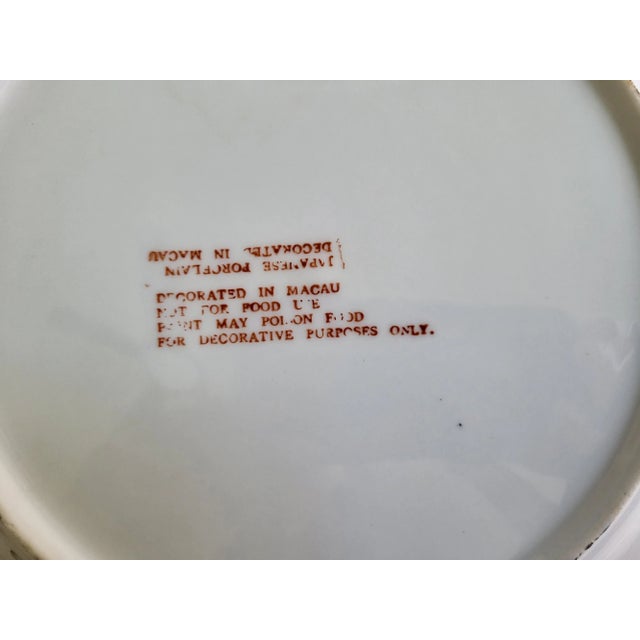 A large Japanese porcelain butterfly and floral plate or platter. Marked 'Decorated in Macau - Decorative Use Only'. While...