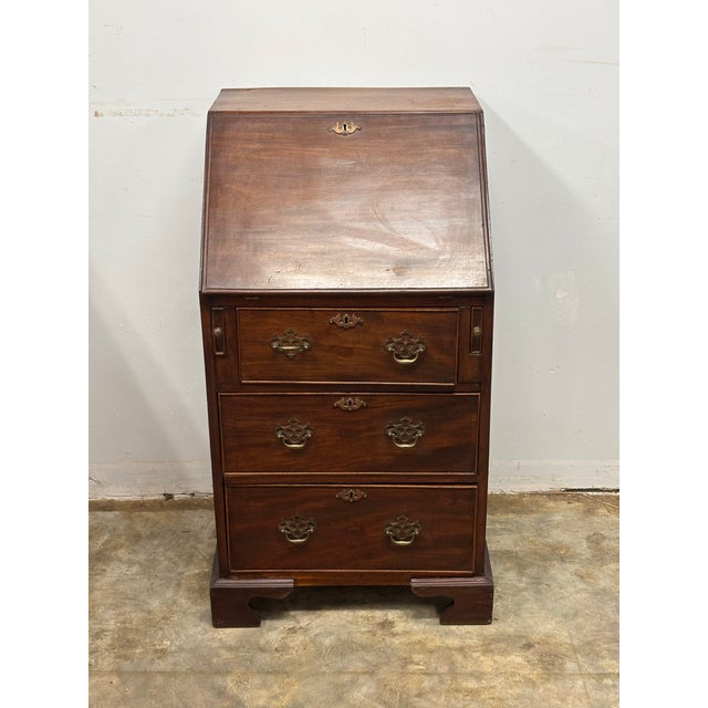 A handsome 18th century English Georgian mahogany slant front bureau desk, a piece that speaks beautifully to the...