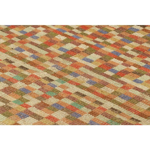 Hand-knotted in wool circa 1960-1970, this 3x5 vintage rug is an exciting new piece in Rug & Kilim’s Mid-Century Pasha...