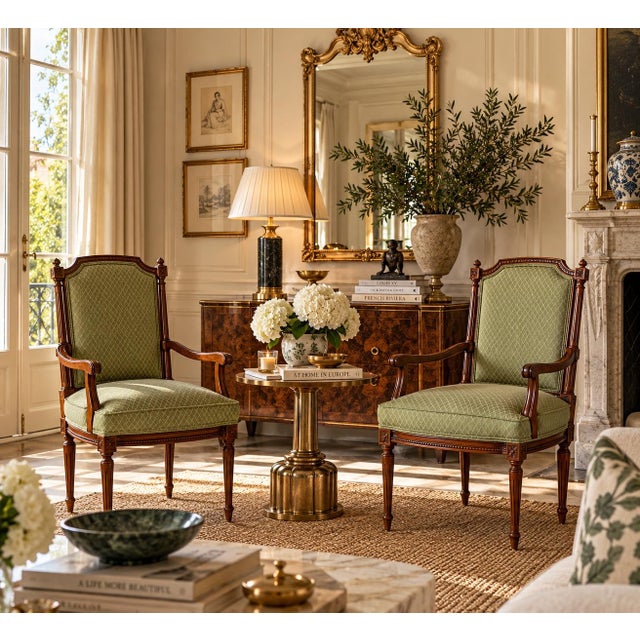 Elegant pair of vintage 1970s French Louis XVI-style armchairs featuring beautifully carved walnut frames with intricate...
