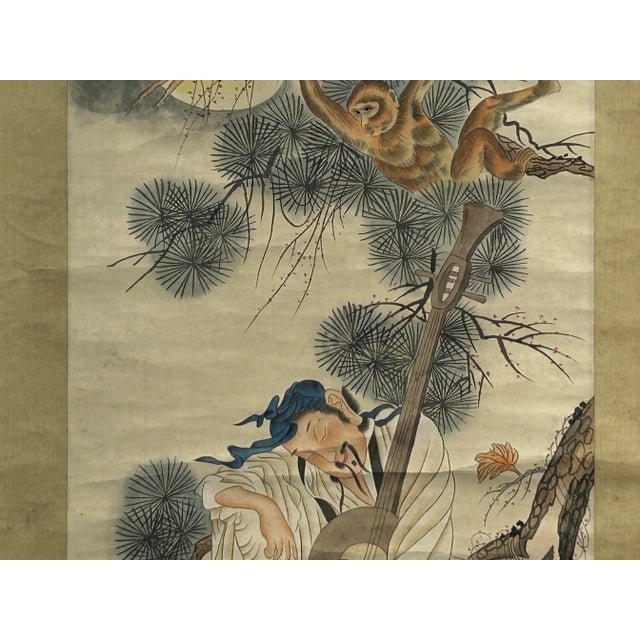 The artwork, meticulously rendered in ink and color on silk, depicts a sage-like figure dozing peacefully against a large...