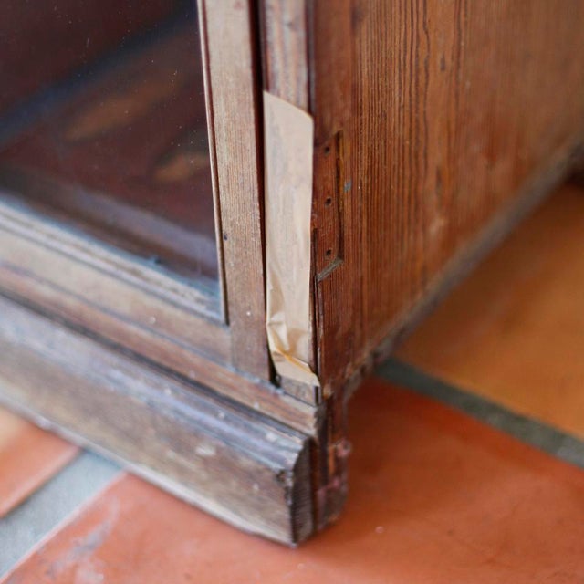 Mid-19th century English pine hunting cabinet. Mellow English pine with original glass. Large lower pull-out used to store...