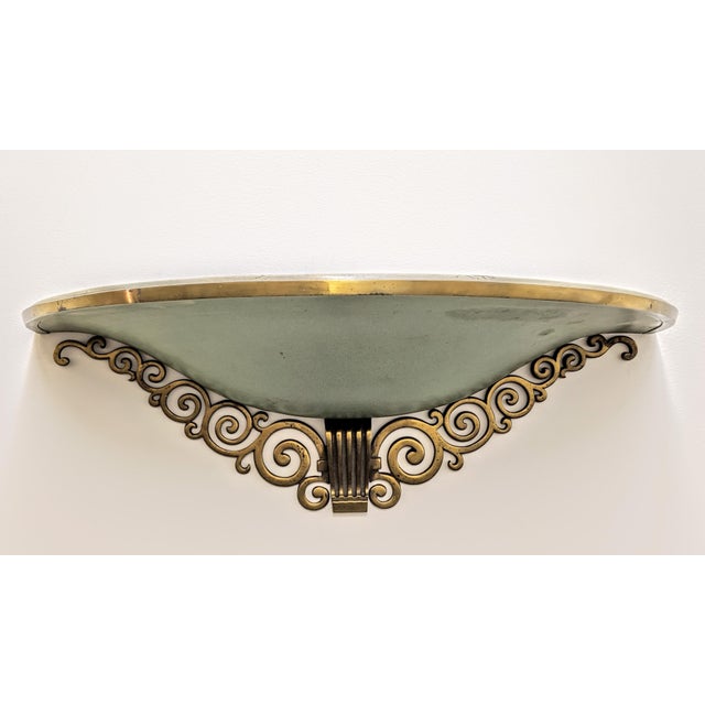 A pair of French Art Deco grand scale (Measures: Width 23.25", depth 11.25", height 7.75") wall sconces enhanced by scroll...