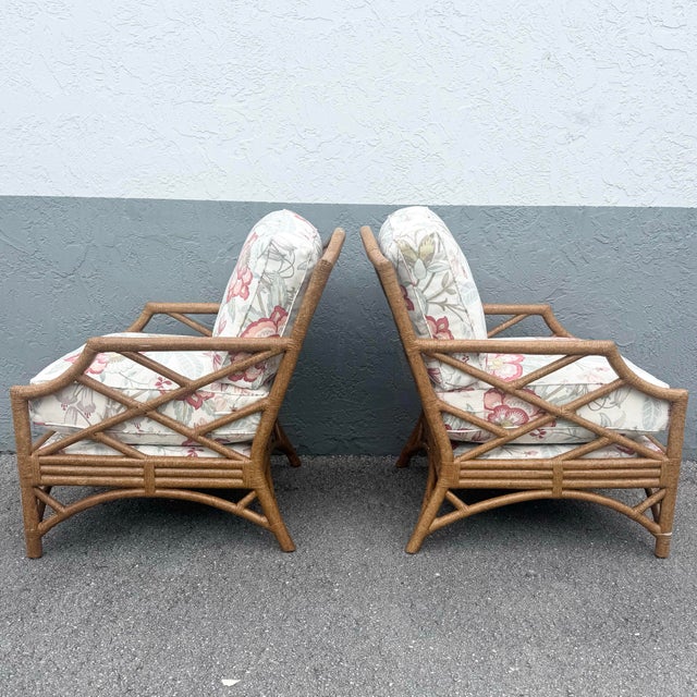 A striking pair of vintage David Francis lounge chairs, showcasing iconic Chippendale-inspired rattan craftsmanship with...