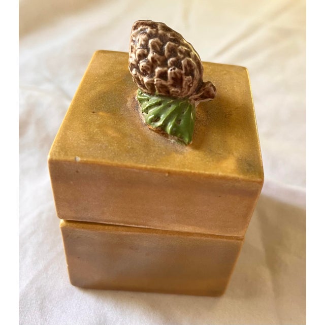 Charming vintage ceramic trinket box with a drippy mustard yellow glaze and acorn finial. No makers mark.