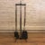 Four piece set of Mid-Century Modern, fireplace tools features looped wrought iron frame and tools with brass inserts. The...
