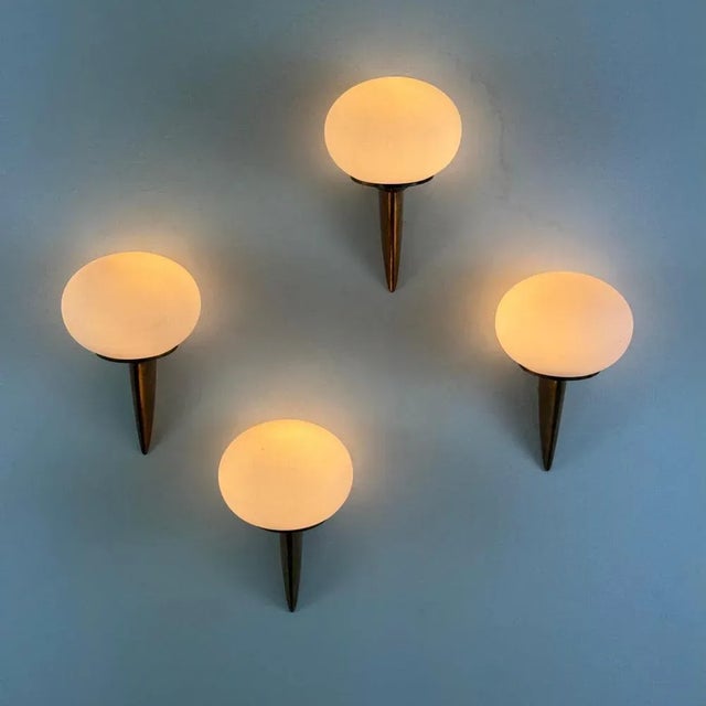 efined and sculptural, this striking set of wall sconces — informally referred to as “lancia” for their resemblance to a...