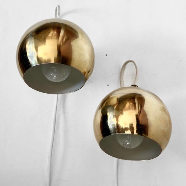 A pair of wall lamps, model magnetlampan (“the magnetic lamp”), produced by the swedish manufacturer konsthantverk ab in...