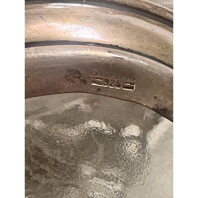 This is a heavy dimple pinch bottle with Sterling overlay at top and down sides. along with a Sterling cap (with intact...