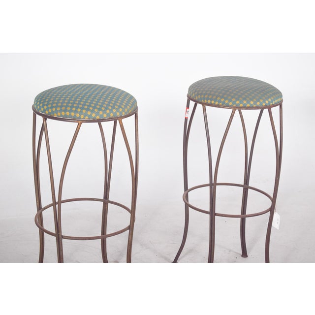 Pair of tall metal stools. Ideal for bar, kitchen or counter environments, they have an elegant, slender design. With four...