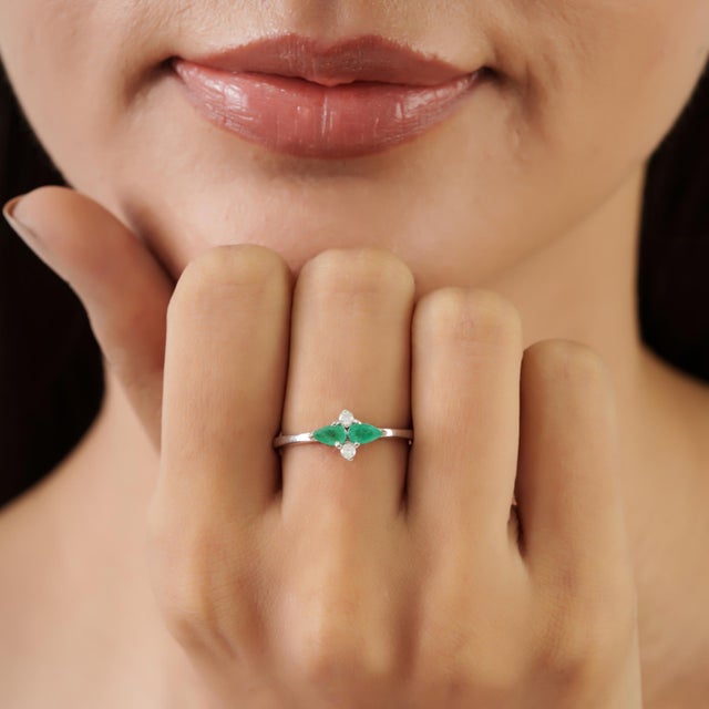 Carat&Her’s Emerald & Diamond Wing Engagement ring features two pear-shaped emeralds arranged in a graceful wing-inspired...